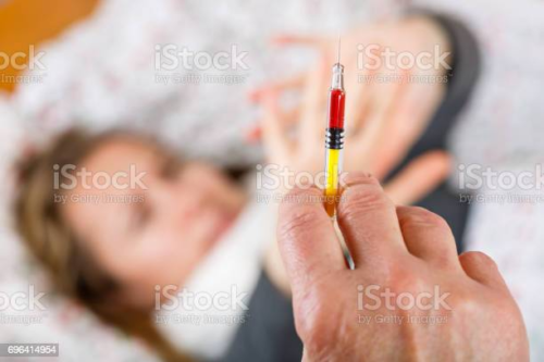 iStock photo of scary needle and frightened patient
