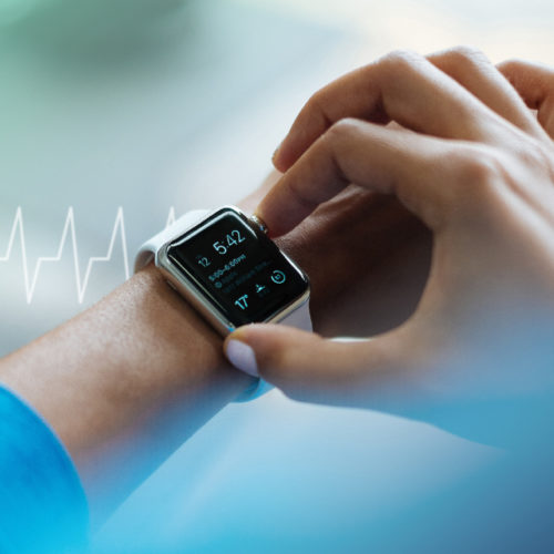 Photo of Apple Watch 3 overlaid with an EKG to demonstrate HealthTech content