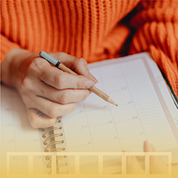 Woman working with a calendar with a digital overlay depicting Golden Spiral's philosophy of building a winning content calendar